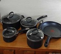Full view of five cookware pieces on surface