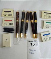 Overview of five fountain pens, cartridge boxes, loose cartridges