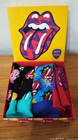 Socks boxed set showing three pairs inside yellow Rolling Stones lid box