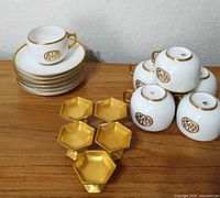 Group shot of cups, saucers and salt cellars on table