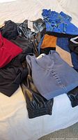 Overview of six clothing items on bed