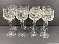 Front view of all eight Cross and Olive cut crystal wine glasses