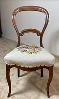 full view of wooden balloon-back chair with floral needlepoint seat