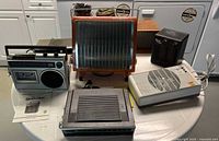 Overview of heaters, radio, speaker on table