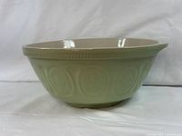 Side view showing green exterior relief pattern and rim detail