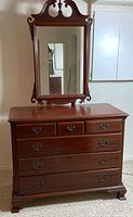 Front view of mahogany dresser with mirror attached