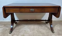 Front view of mahogany coffee table, leaves down