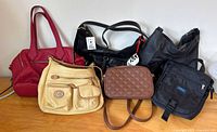 Group shot of five purses and handbags