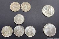 All eight coins grouped, showing obverses and reverses