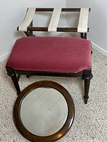 Bench, luggage stand, and round mirror grouped together