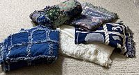 All five folded blankets, throws and quilt grouped