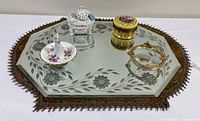 Overall lot showing mirror, mat, two trinket boxes, ring holder, ashtray