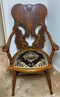 Full view of carved wooden armchair