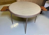 Full view of round folding table with both drink holders extended