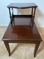 Front angled view showing two tiers, turned supports and cabriole legs