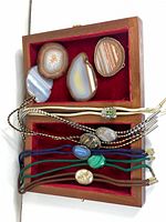Overview of bolo ties, belt buckle slices and display box