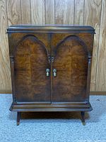 Full front view of liquor cabinet showing overall design and legs