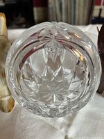 Front view cut crystal sphere between onyx and wood elephants