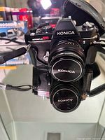 Front view of Konica Autoreflex TC SLR with lens and body cap