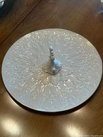 Top view of Lenox ivory cake plate with embossed design and central handle