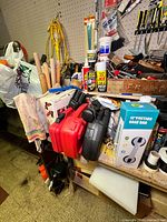 Overall view of tabletop with tools, cases, boxed grab bar, extension cord