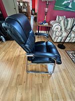 Left side view of black chair showing chrome cantilever base