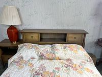 Front view of wooden storage headboard attached to bed frame