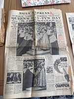 Front page of Daily Express newspaper showing Queen Elizabeth II during coronation events with headlines and black-and-white photos.