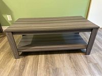 Front view of entire coffee table showing top, legs, lower shelf