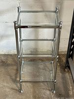 Full front view showing chrome frame and three beveled glass shelves