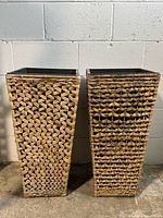 Front view of both tall bamboo woven square planters side by side, showing differing patterns and tapered shape.