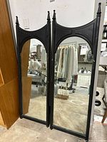 Two full-length black painted mid-century framed mirrors leaning together