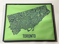 Full framed map poster showing the entire stylized Toronto shape with neighbourhood names and 'TORONTO' titled at bottom.
