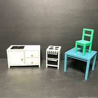 Miniature white kitchen sink cabinet, oven range, blue table with green chair