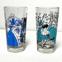 Front view of two Sleeping Beauty glasses showing character artwork in blue and teal with film scenes.