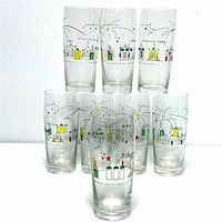 Front view of 8 Heineken beer glasses with colorful space themed utopia graphics showing futuristic structures and orbits