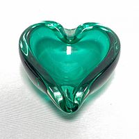 Top view of green heart-shaped glass dish showing transparency, color, and shape.