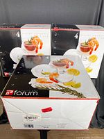 Three boxed sets of Forum Shrimp Cocktail dishes, packaging showing shrimp and lemon design on box.
