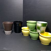 Photo showing all seven planters grouped together highlighting various colors and shapes