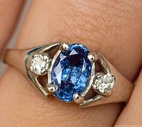 Close-up top view of ring showing oval tanzanite and side diamonds