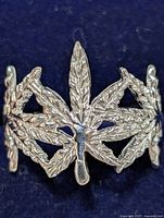 Close-up image showing front view of silver ring with leaf design