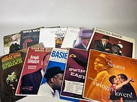 Twelve vinyl record albums including multiple Frank Sinatra albums and other jazz and vocal artists, arranged flat on a white surface.