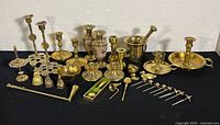 Overall view of all brass items: candlesticks, figurines, mortar and pestle, skewers, vases, and other small brassware