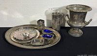 Photo shows the entire silver plated serving set including tray, ice bucket, salt cellars, and small containers on black background
