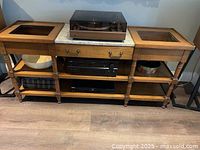 Full front view of the vintage wet dry sink sideboard showing the wooden structure, marble center top, two copper sink inserts, drawers, and open shelves with electronic components on shelves.