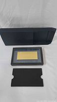 Gold bar in acrylic holder inside presentation box with sleeve