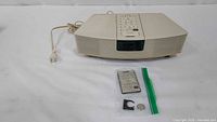 Bose Wave Radio front view with remote, battery and clip