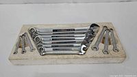 Full set of 11 wrenches displayed on foam board