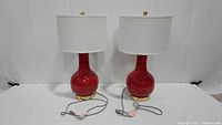 Full view of both red Safavieh lamps with cords visible