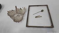 Leaf-shaped dish, picture frame, stick pin, bar pin displayed